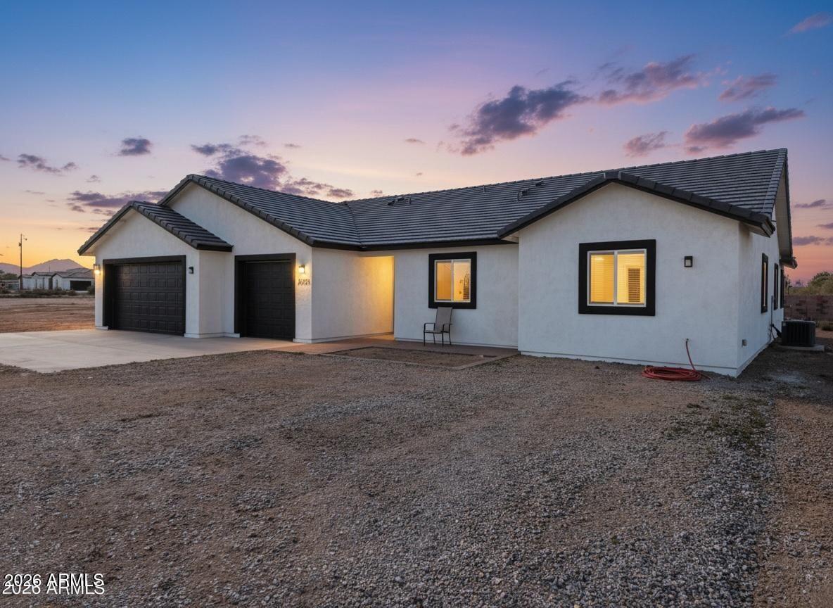20735 West Elliot Road Buckeye, AZ 85326 - Photo 7 of 59 a view of a house with a yard and garage