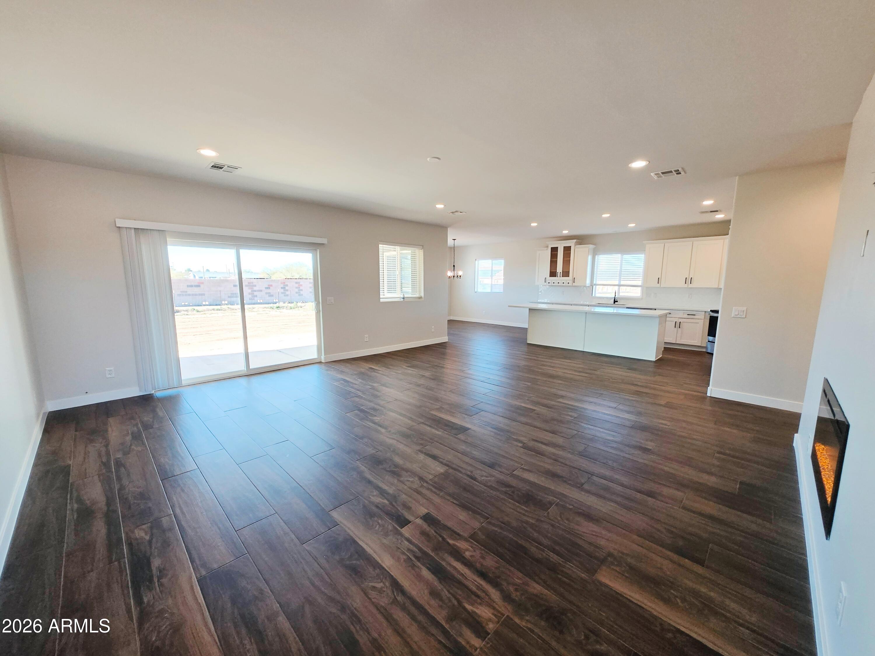 20735 West Elliot Road Buckeye, AZ 85326 - Photo 8 of 59 a view of kitchen and hall with wooden floor