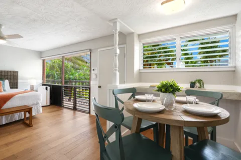 a view of a dining room with furniture and wooden floor