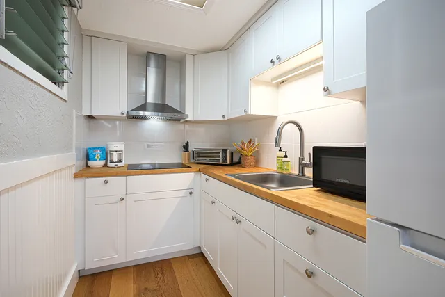 a kitchen with a sink and cabinets