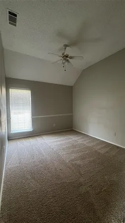 a view of empty room with wooden floor and fireplace