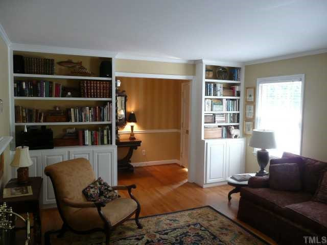 Another view of the living room showing built-ins and entry foyer to welcome guests.
