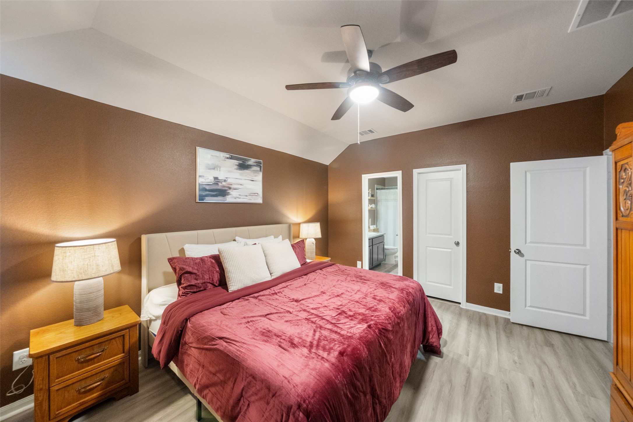 26431 Pin Oak Drive Hempstead, TX 77445 - Photo 17 of 32 Another view of the primary bedroom highlighting the private en-suite access and bright, airy feel.