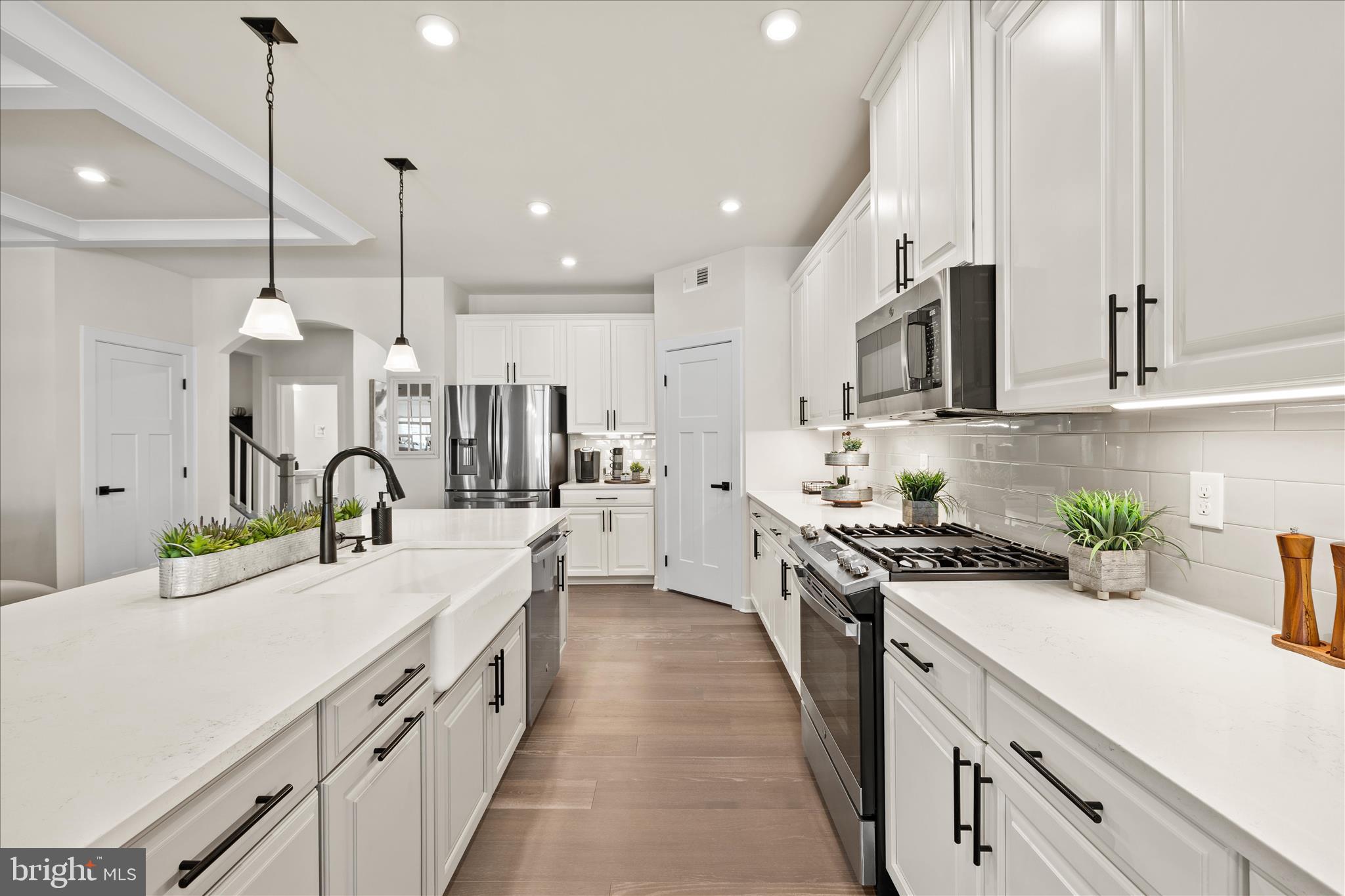 32225 Heritage Road Lewes, DE 19958 - Photo 13 of 74 a large kitchen with stainless steel appliances lots of counter space sink and cabinets