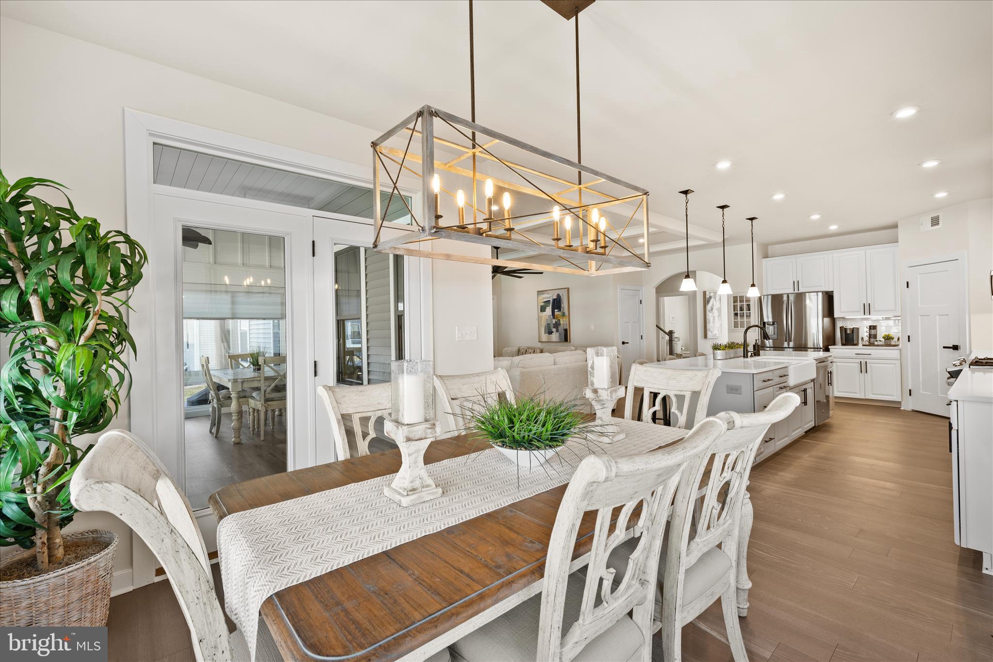 32225 Heritage Road Lewes, DE 19958 - Photo 15 of 74 a view of a dining room and livingroom with furniture wooden floor a chandelier