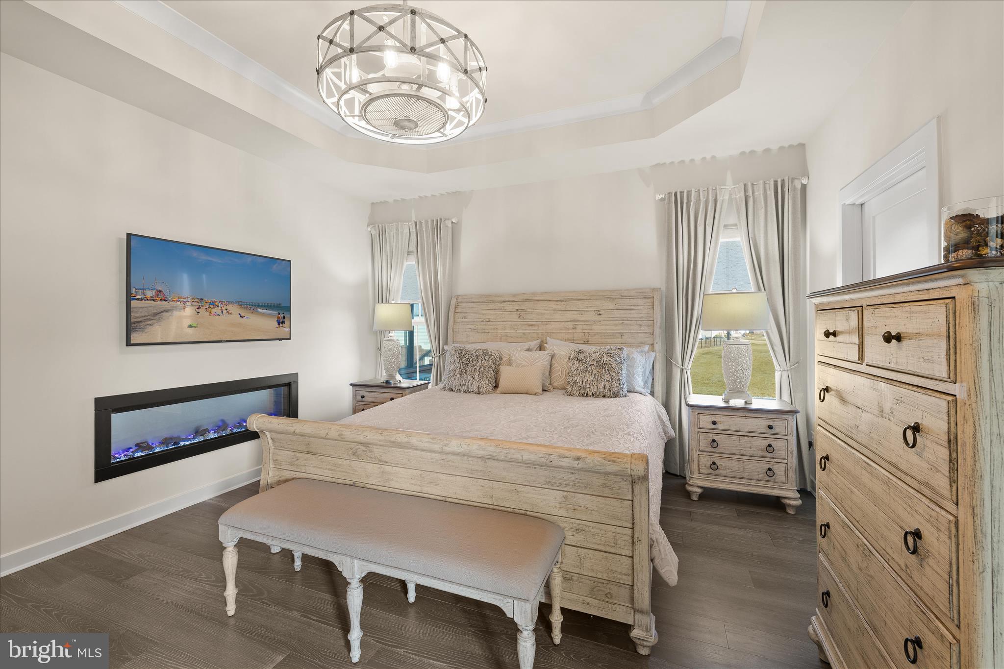 32225 Heritage Road Lewes, DE 19958 - Photo 22 of 74 a bedroom with a bed and a chandelier