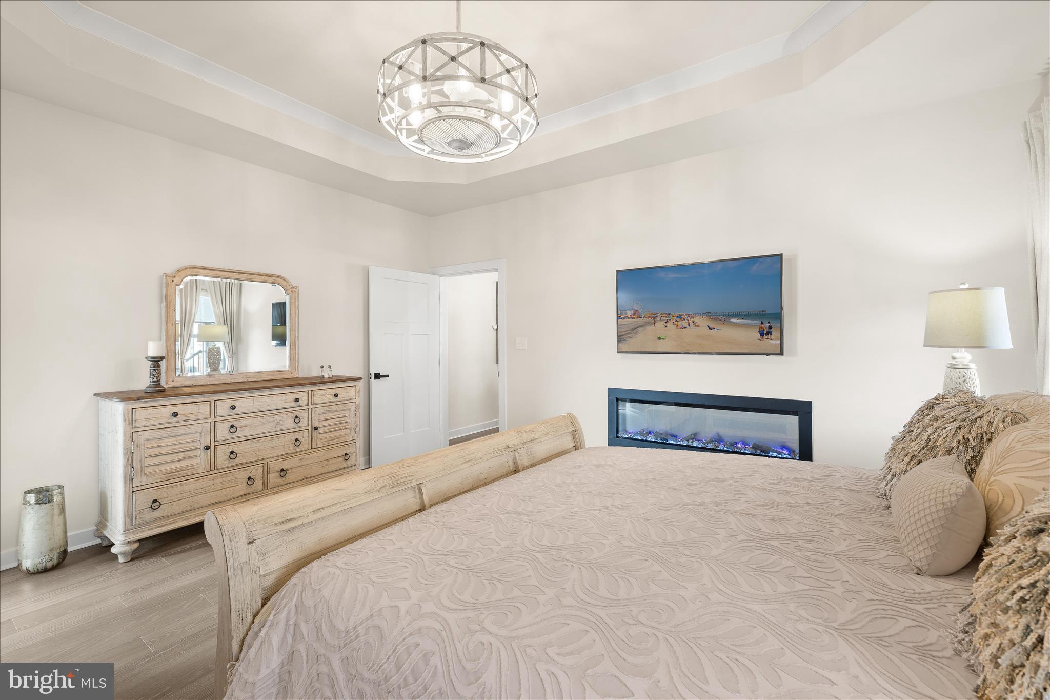 32225 Heritage Road Lewes, DE 19958 - Photo 24 of 74 a bedroom with a bed and a chandelier