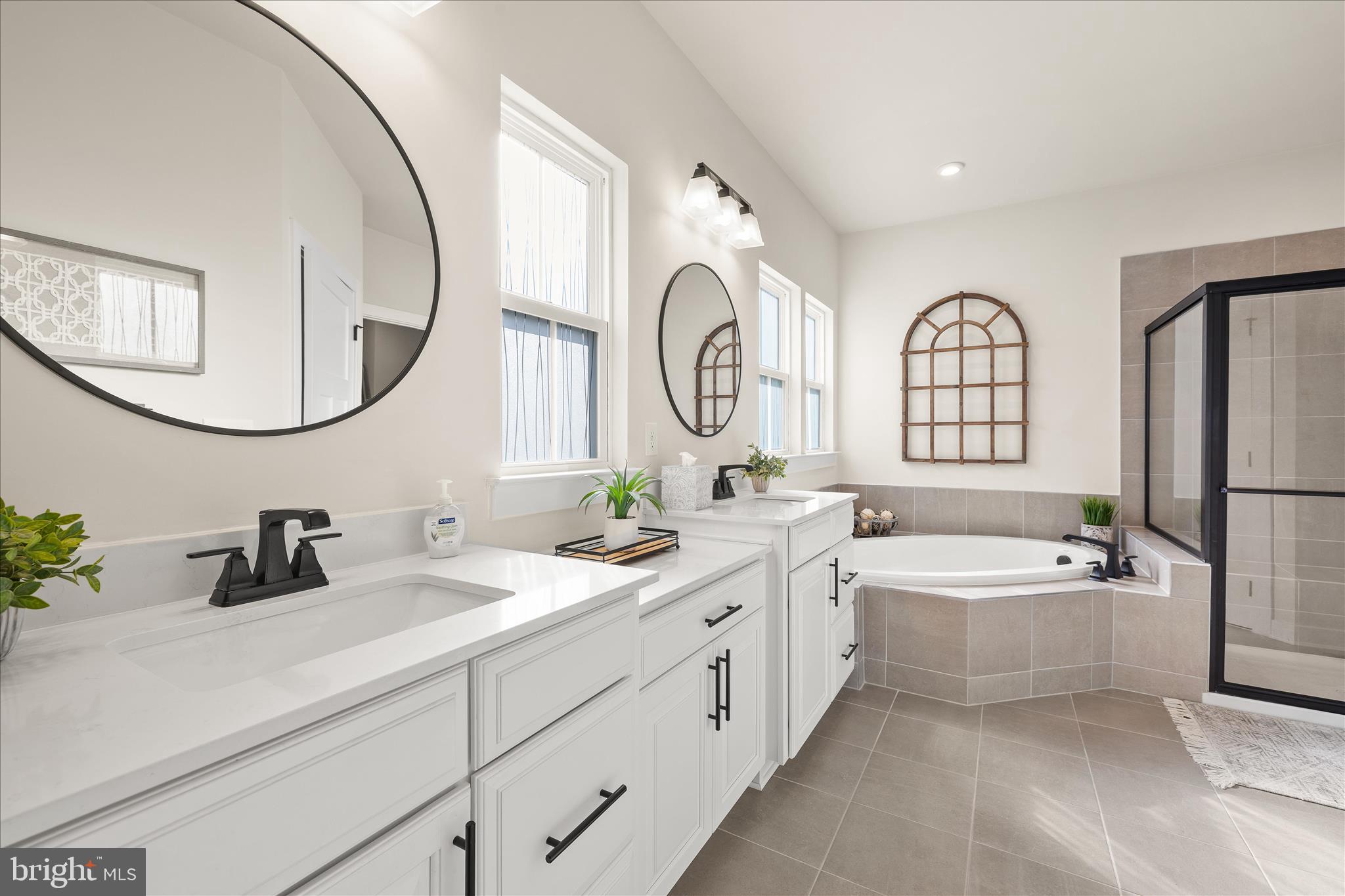 32225 Heritage Road Lewes, DE 19958 - Photo 25 of 74 a spacious bathroom with a double vanity sink mirror double bathtub and shower