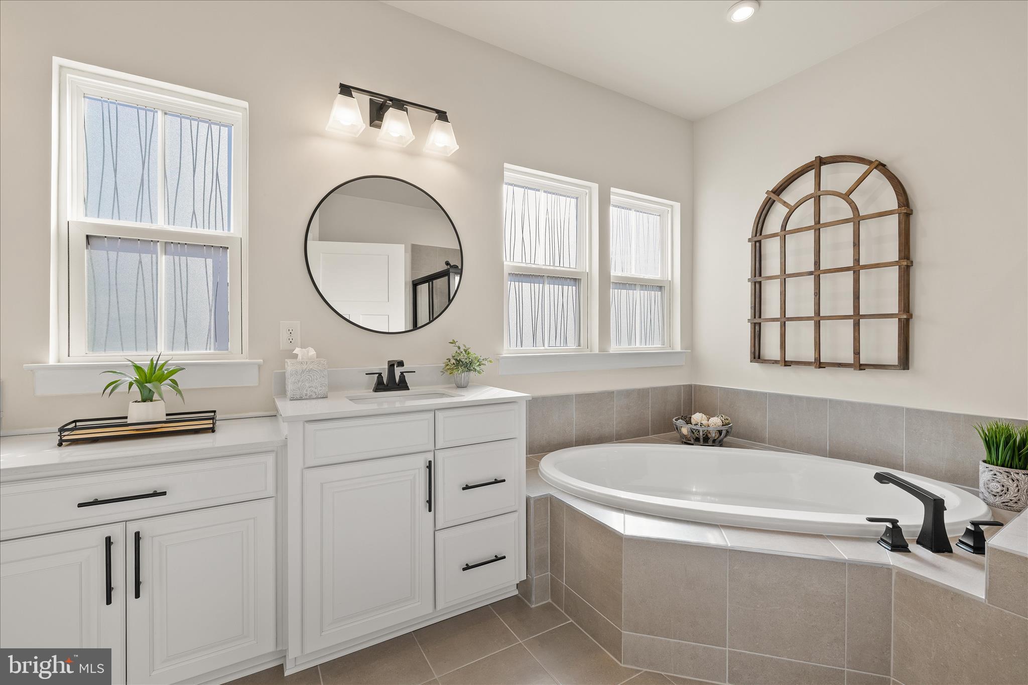 32225 Heritage Road Lewes, DE 19958 - Photo 27 of 74 a bathroom with a tub a double vanity sink and a window