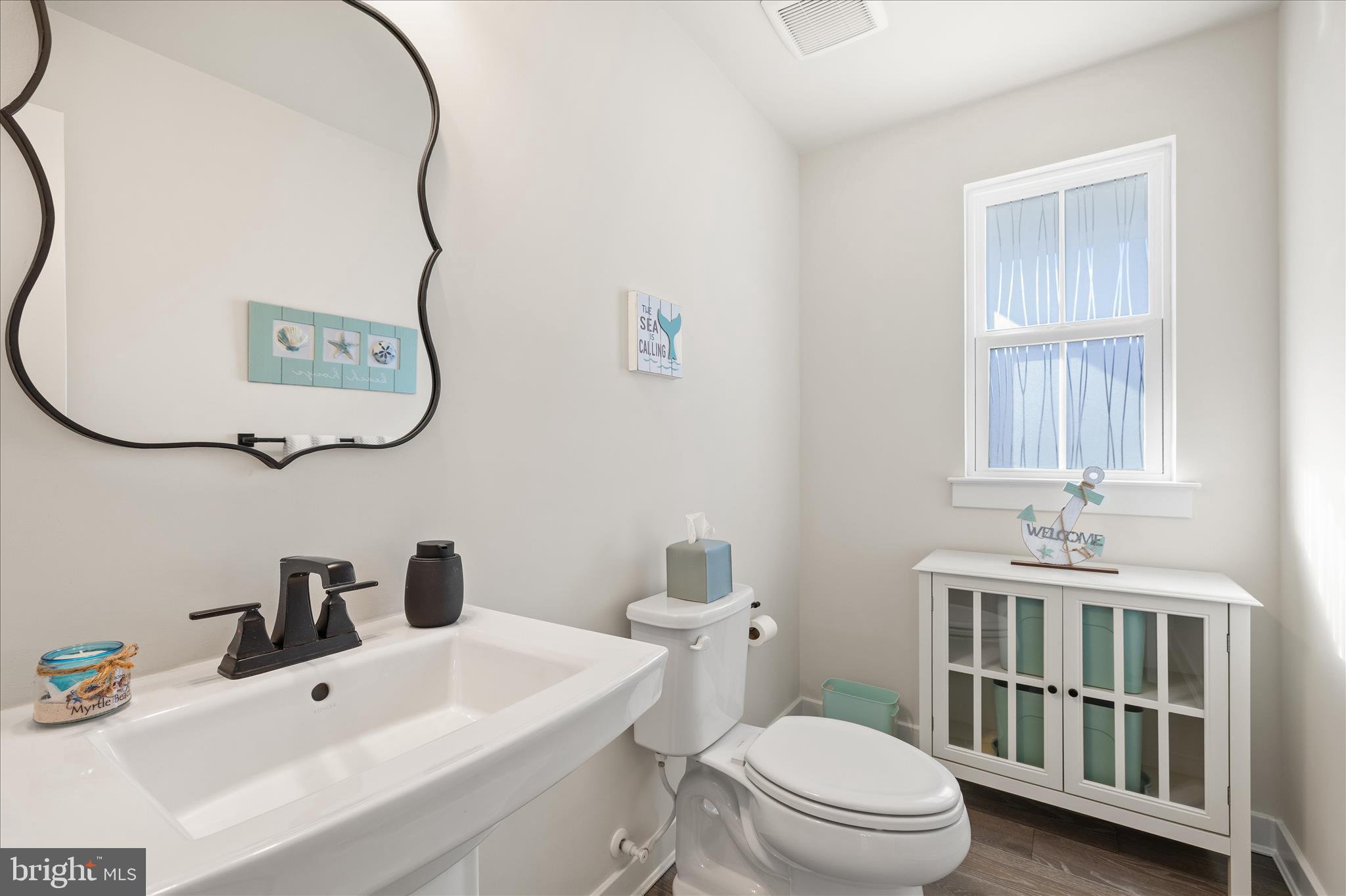 32225 Heritage Road Lewes, DE 19958 - Photo 34 of 74 a bathroom with a sink a toilet and a mirror