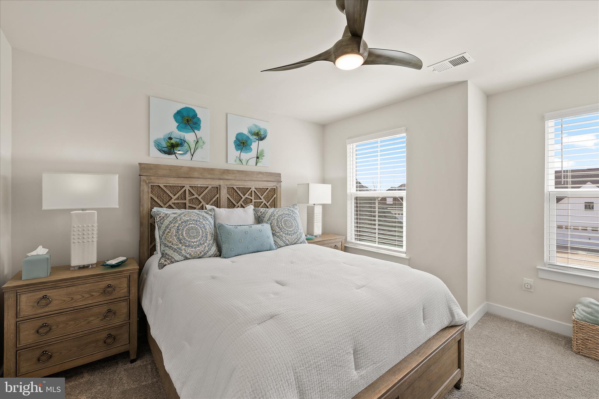 32225 Heritage Road Lewes, DE 19958 - Photo 46 of 74 a bedroom with a bed a dresser and a window