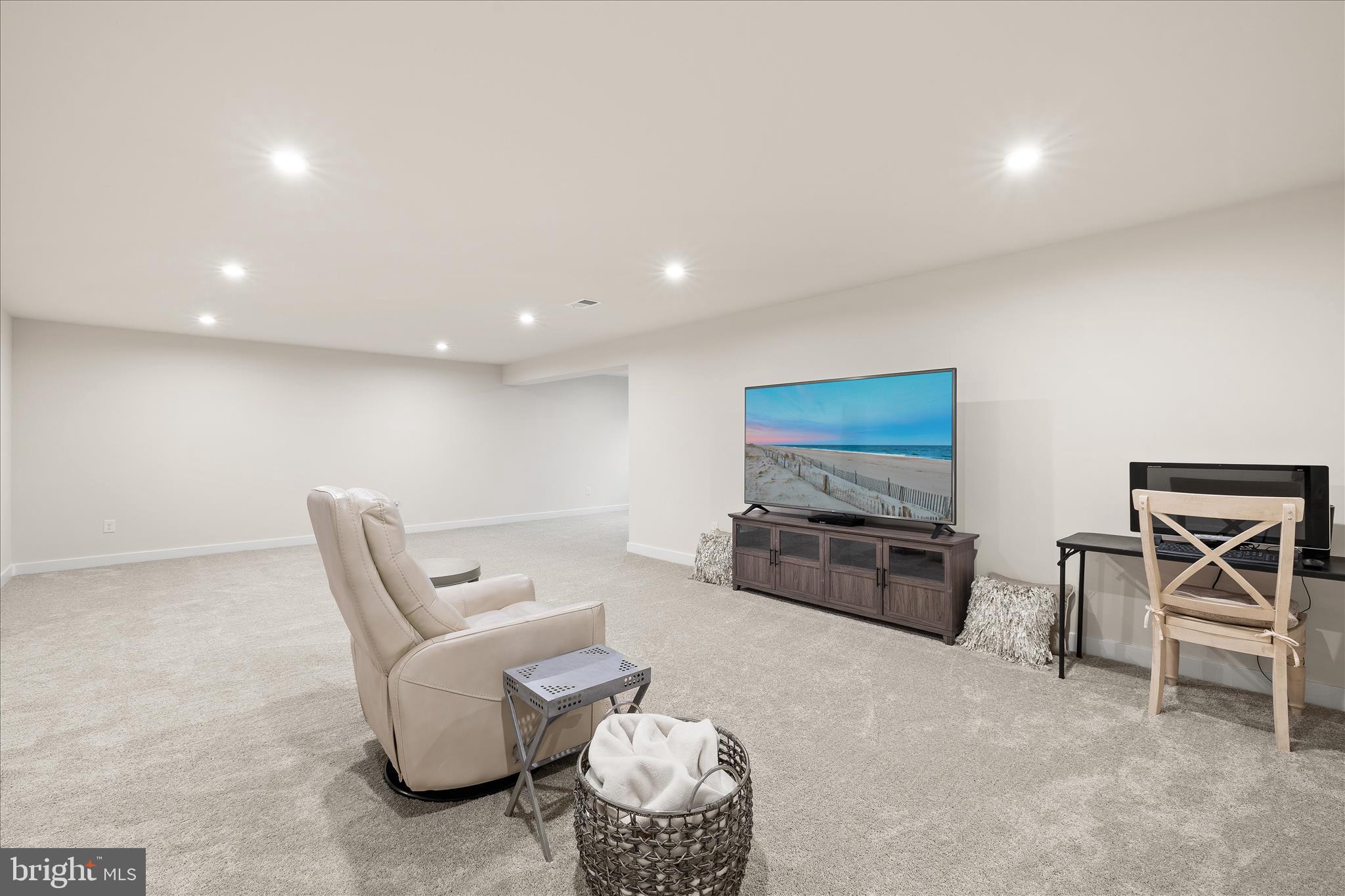 32225 Heritage Road Lewes, DE 19958 - Photo 51 of 74 a living room with furniture a flat screen tv and gym equipment