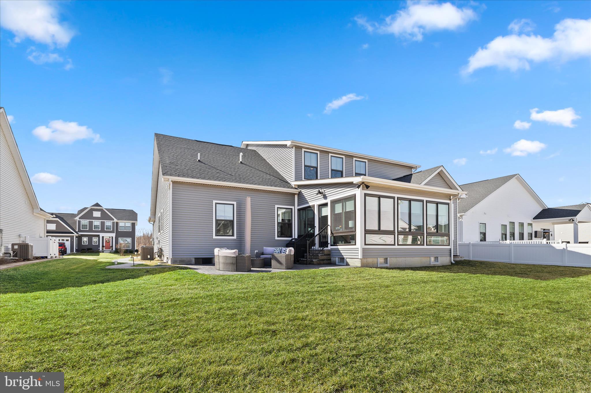 32225 Heritage Road Lewes, DE 19958 - Photo 58 of 74 a front view of a house with a garden and yard
