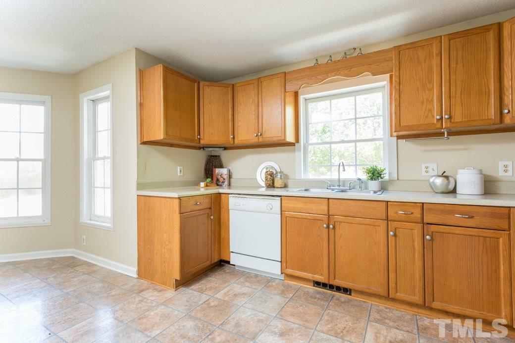 796 Old Eason Road Zebulon, NC 27597 - Photo 4 of 11 Large open kitchen features NEW Fixtures & freshly painted. All the hardware has been changed to BRUSHED NICKEL.