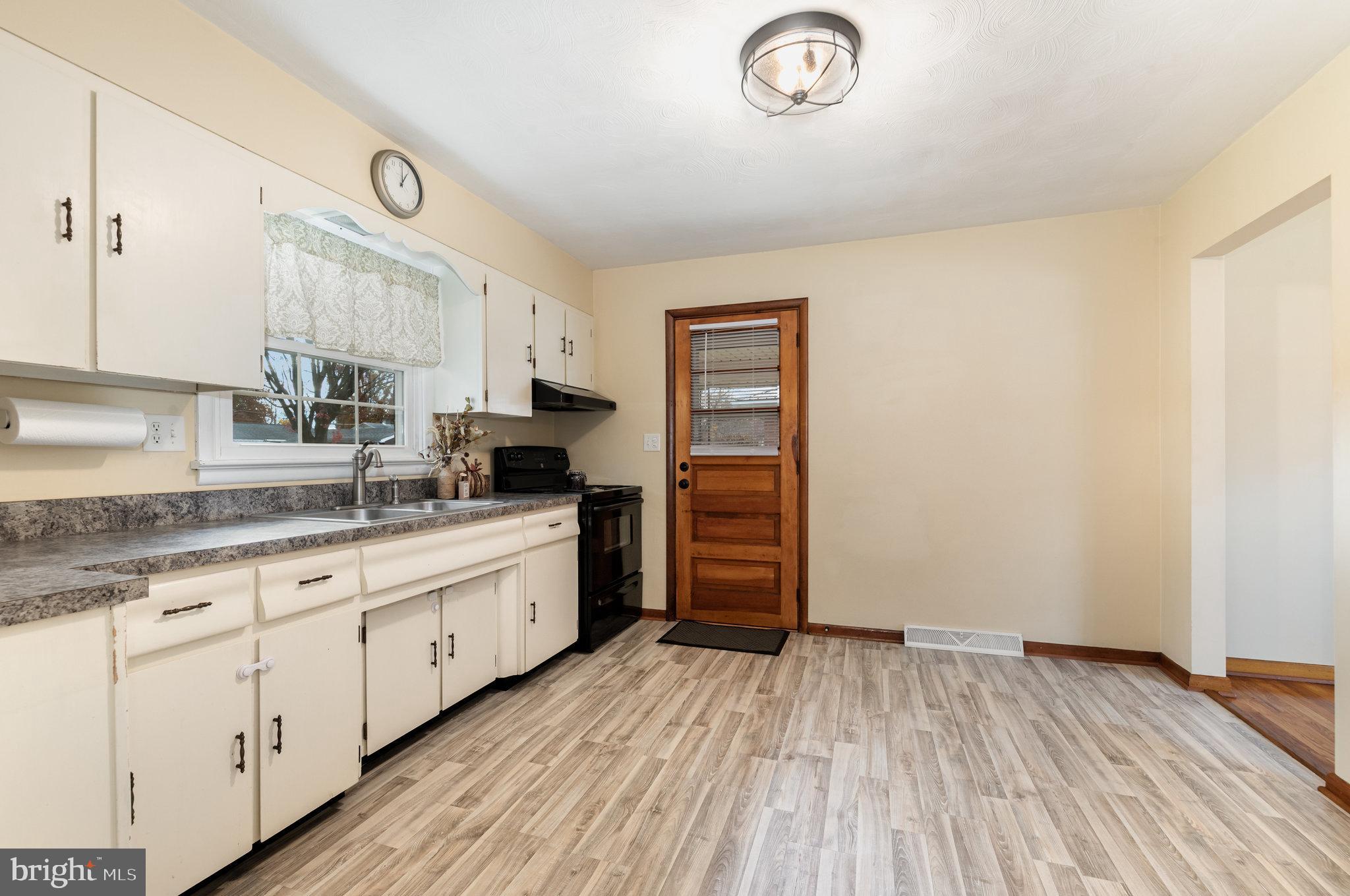 20 Chestnut Street Camp Hill, PA 17011 - Photo 11 of 26 a kitchen with granite countertop a stove a sink and a refrigerator
