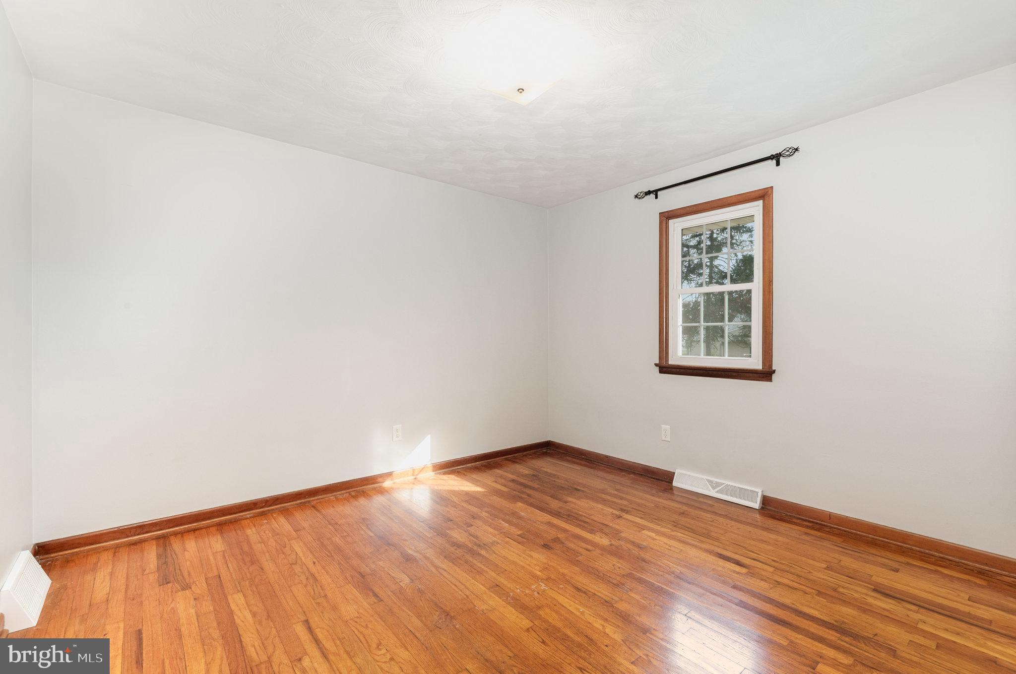 20 Chestnut Street Camp Hill, PA 17011 - Photo 17 of 26 an empty room with wooden floor and windows
