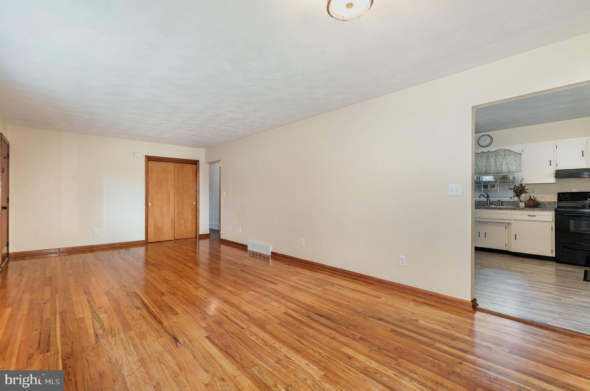 20 Chestnut Street Camp Hill, PA 17011 - Photo 7 of 26 a view of empty room with wooden floor and kitchen view