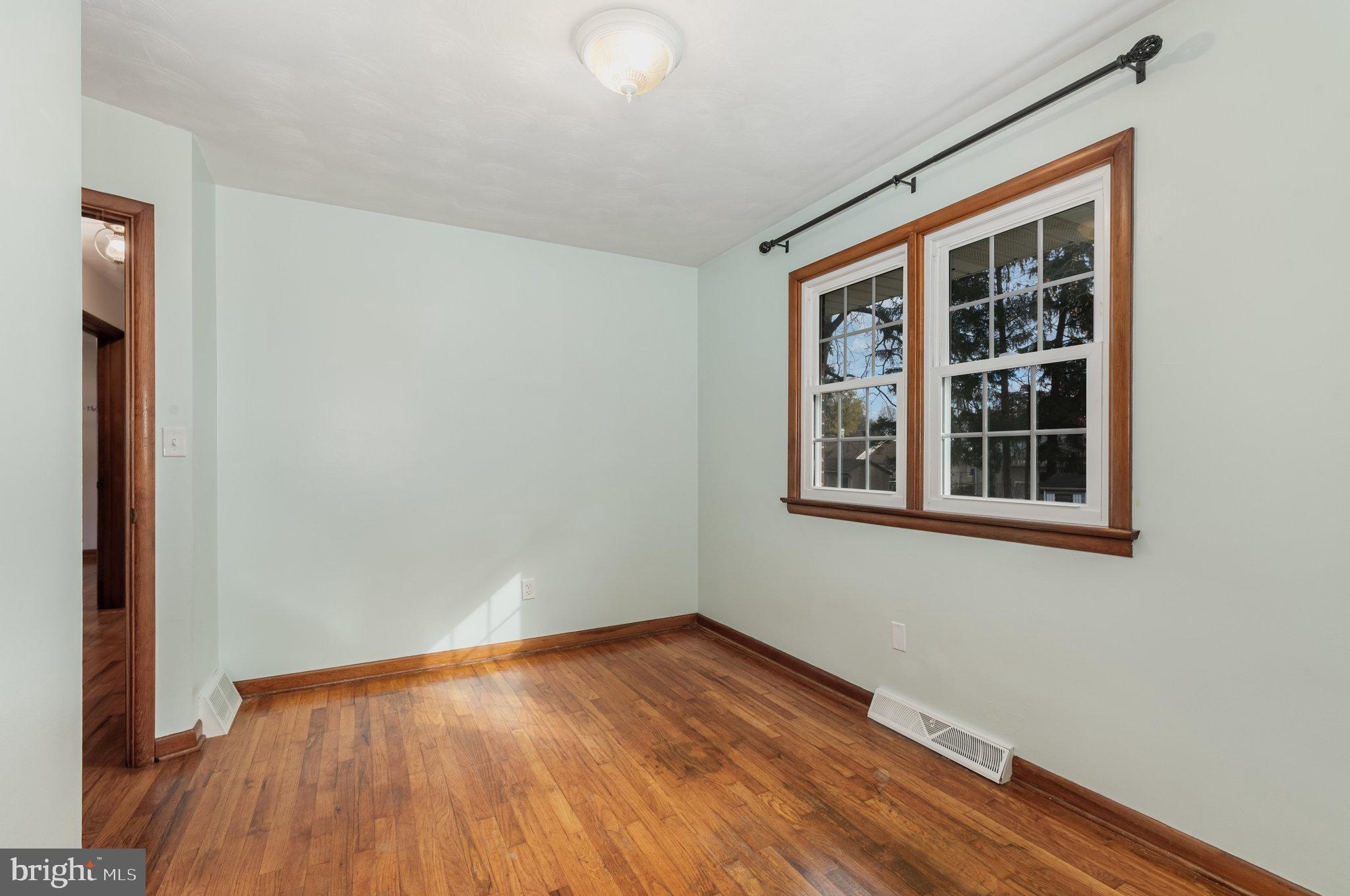 20 Chestnut Street Camp Hill, PA 17011 - Photo 9 of 26 a view of an empty room with wooden floor and a window