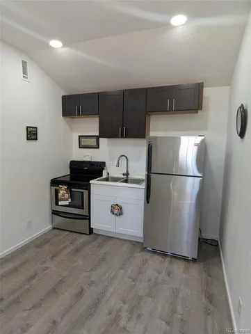 a kitchen with stainless steel appliances a refrigerator and a stove top oven