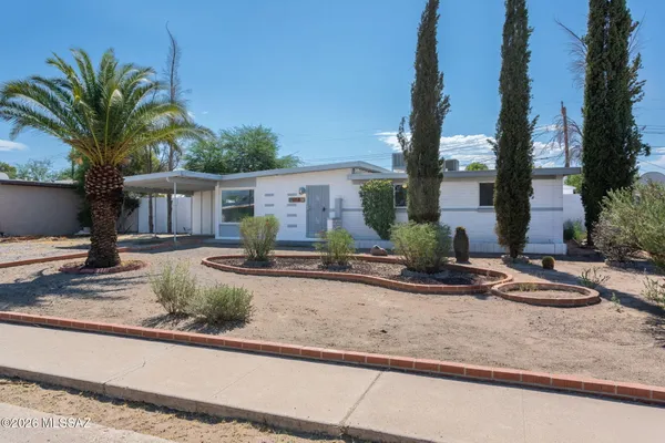 a view of a house with small yard and plants