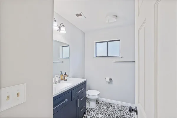 a bathroom with a sink vanity and a mirror