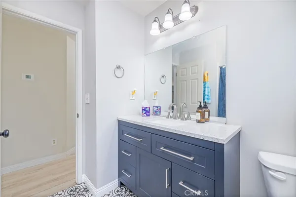 a bathroom with a sink vanity and a mirror