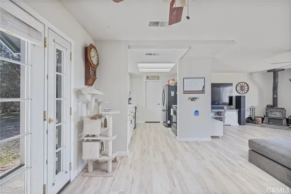 a kitchen with white cabinets and white appliances