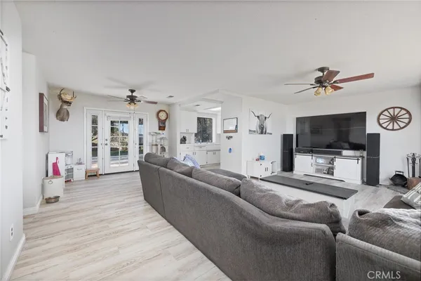a living room with furniture and kitchen view