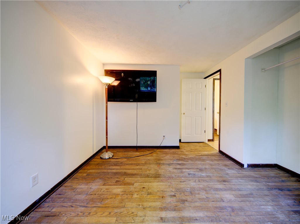 8075 Mulberry Road Chesterland, OH 44026 - Photo 23 of 38 Unfurnished bedroom with wood-type flooring and a closet