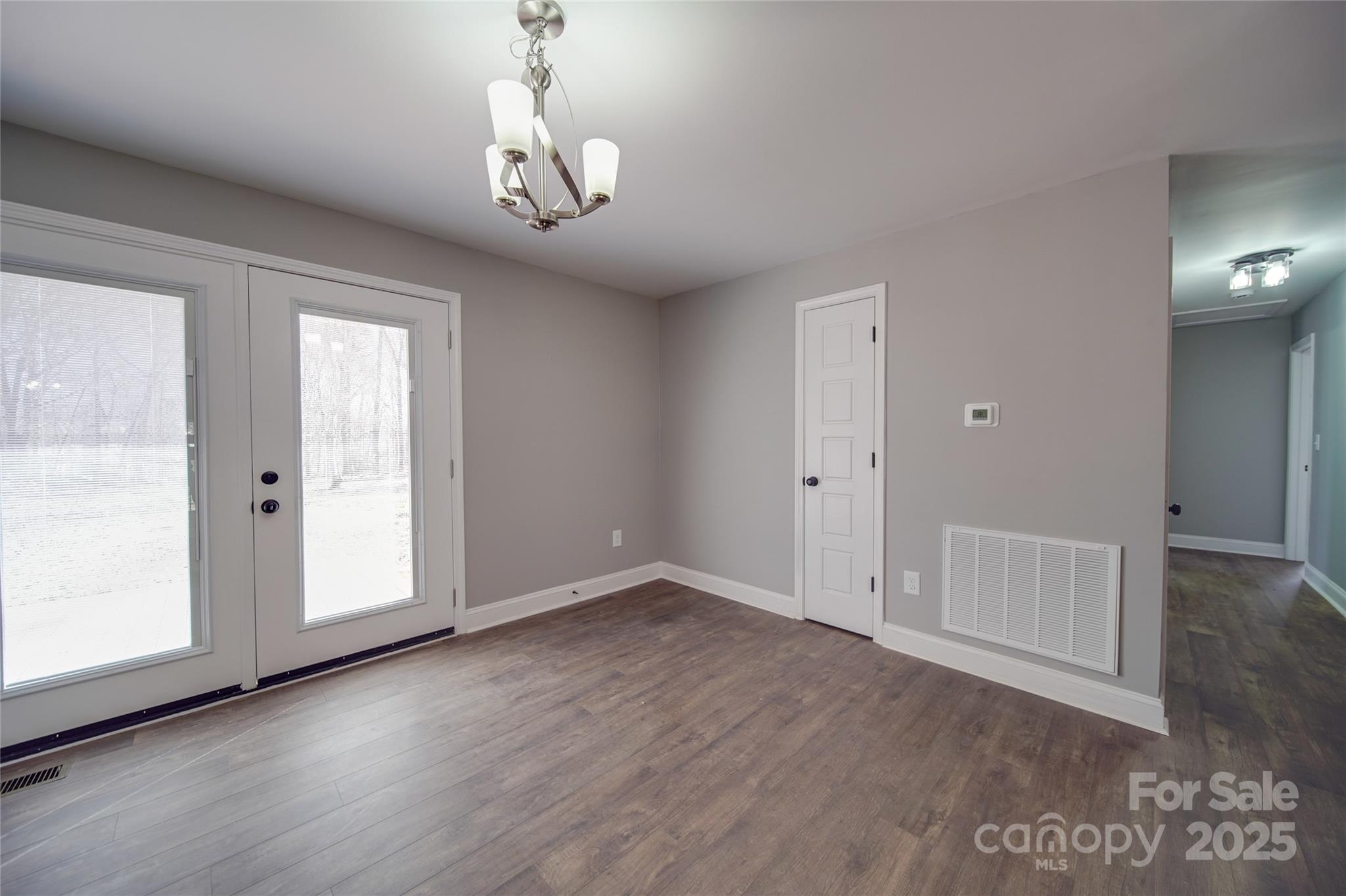 3210 Puetts Chapel Road Dallas, NC 28034 - Photo 4 of 11 an empty room with wooden floor and windows