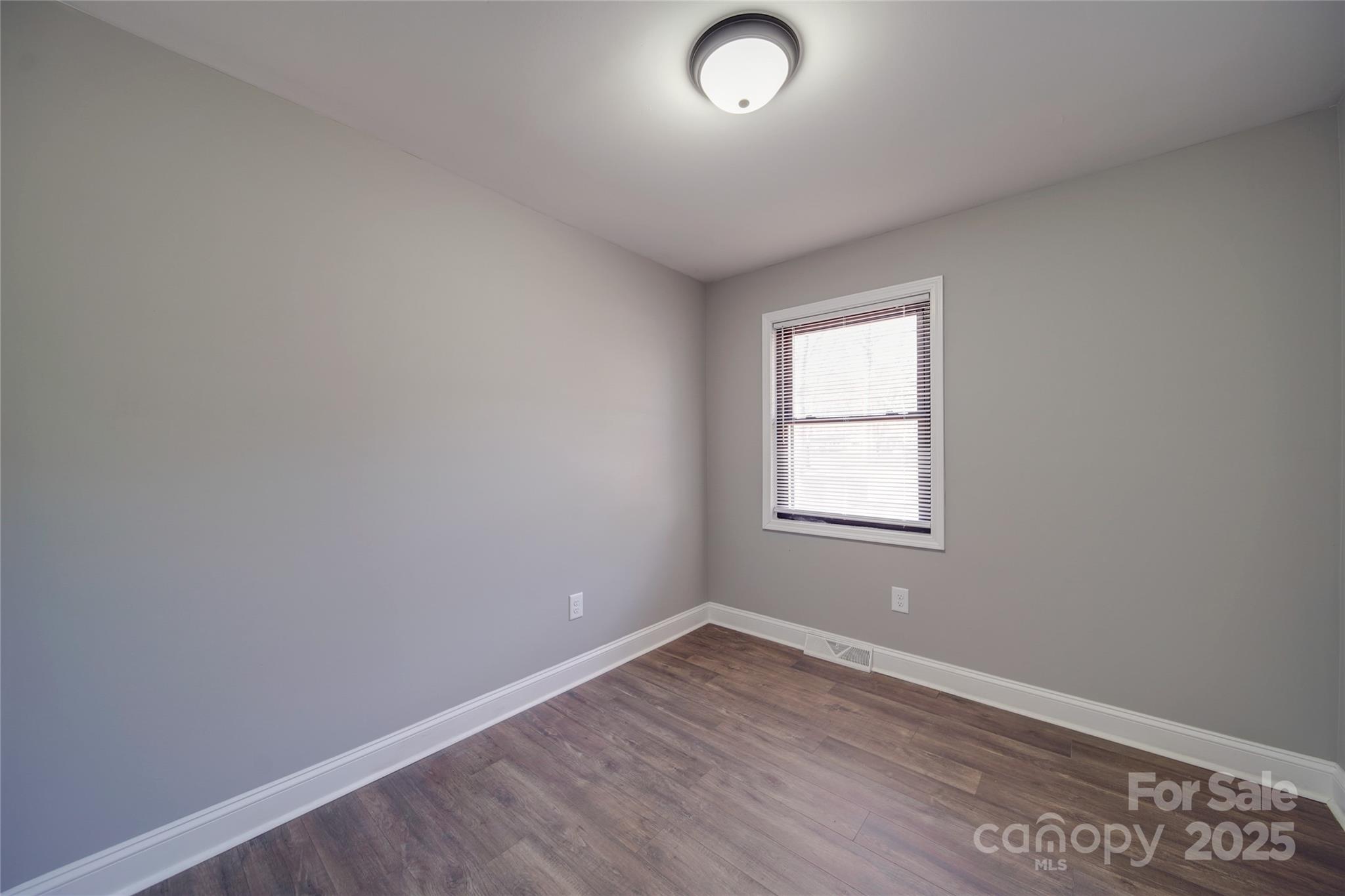 3210 Puetts Chapel Road Dallas, NC 28034 - Photo 6 of 11 an empty room with wooden floor and windows