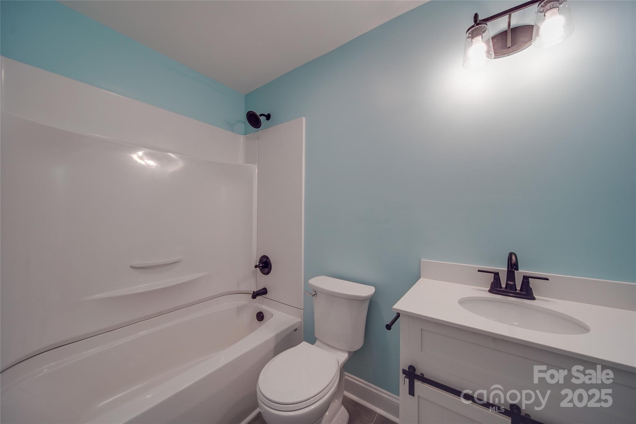 3210 Puetts Chapel Road Dallas, NC 28034 - Photo 7 of 11 a white toilet sitting next to a bath tub