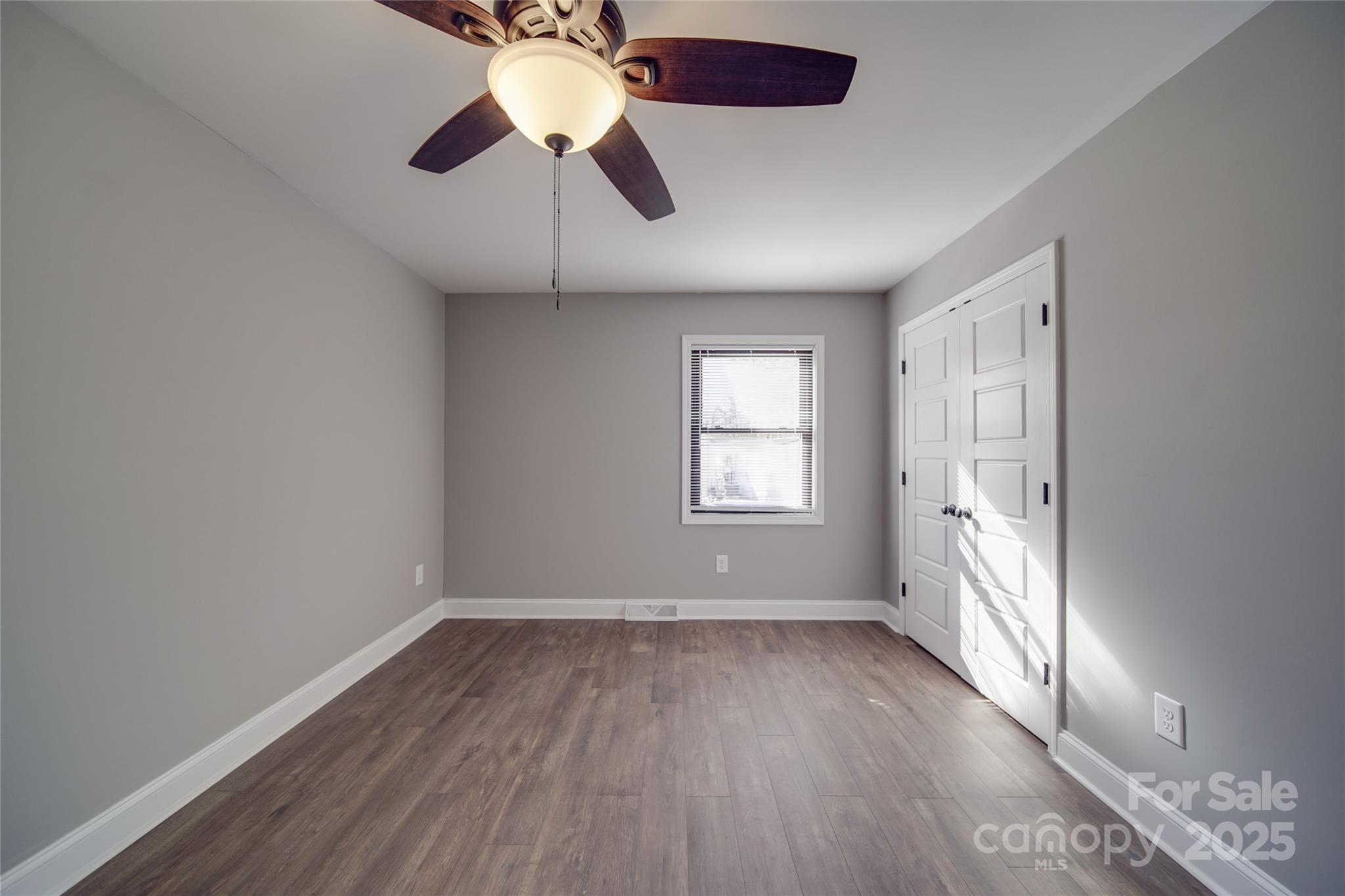 3210 Puetts Chapel Road Dallas, NC 28034 - Photo 8 of 11 wooden floor in an empty room with a window