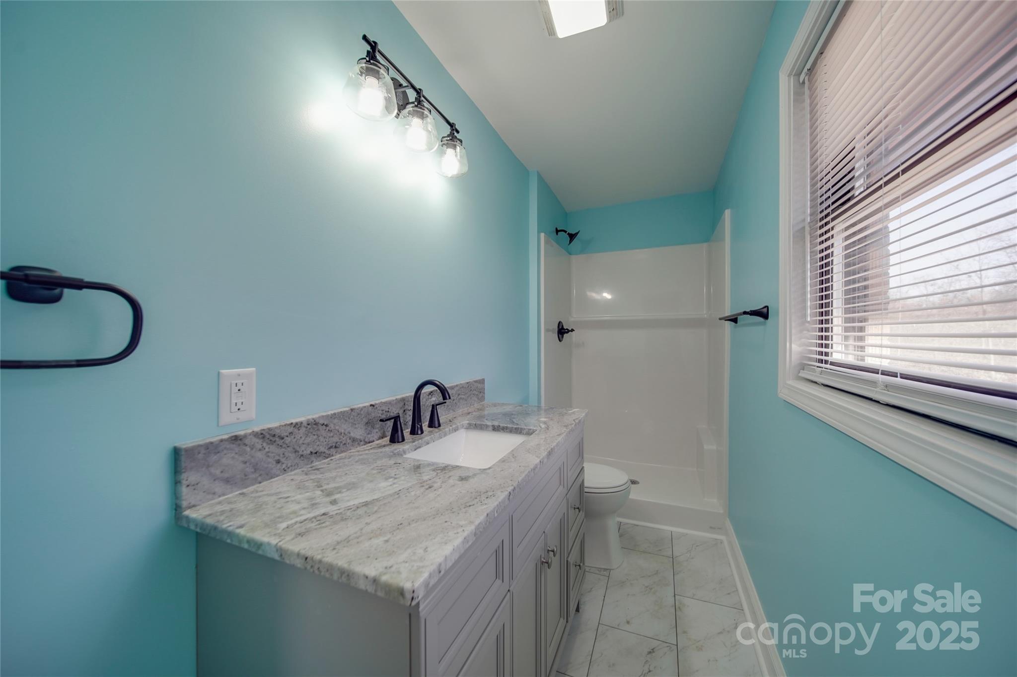3210 Puetts Chapel Road Dallas, NC 28034 - Photo 10 of 11 a bathroom with a sink and a mirror