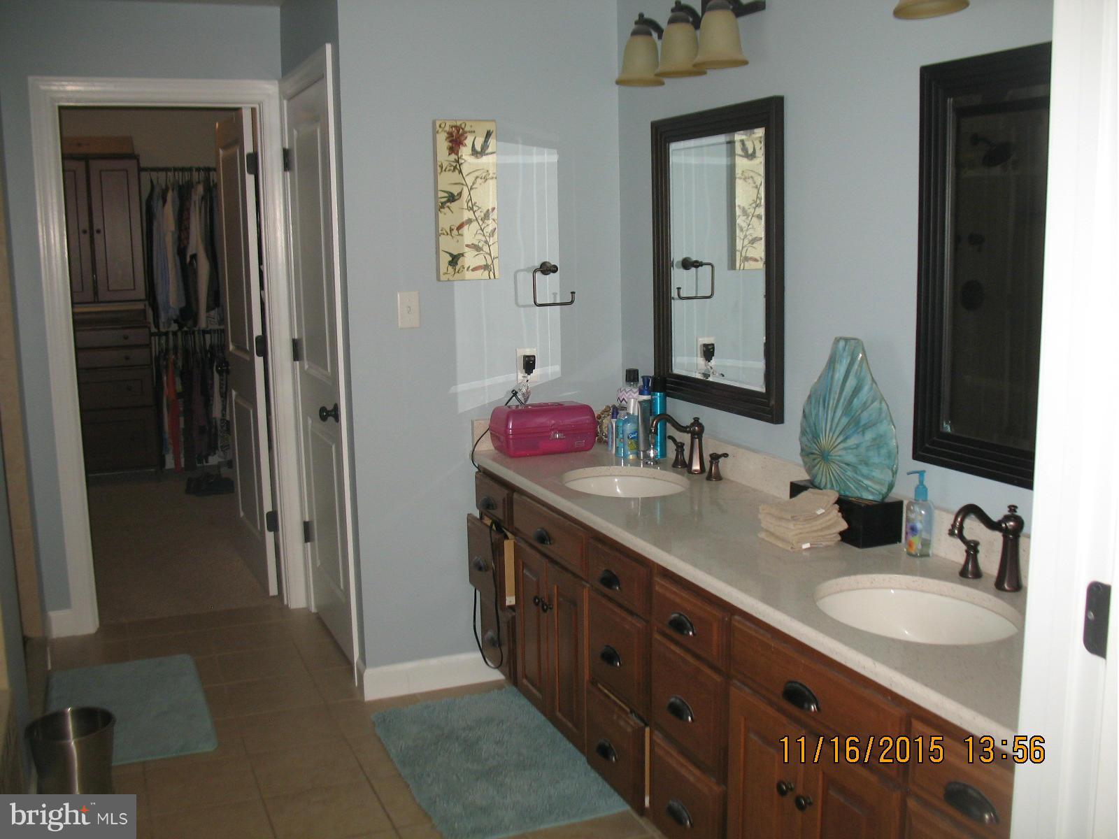 13908 Barnhart Road Clear Spring, MD 21722 - Photo 11 of 16 a bathroom with a double vanity sink and a mirror