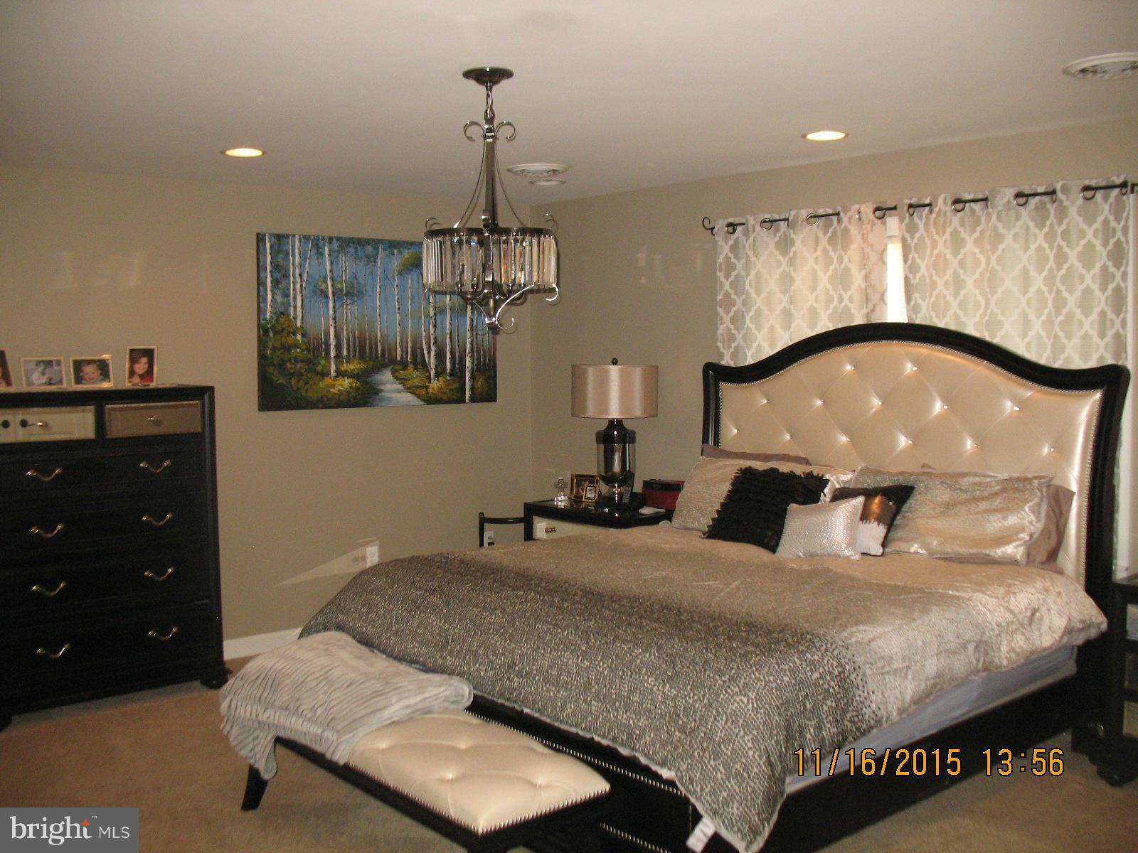 13908 Barnhart Road Clear Spring, MD 21722 - Photo 12 of 16 a bedroom with a large bed and a dresser