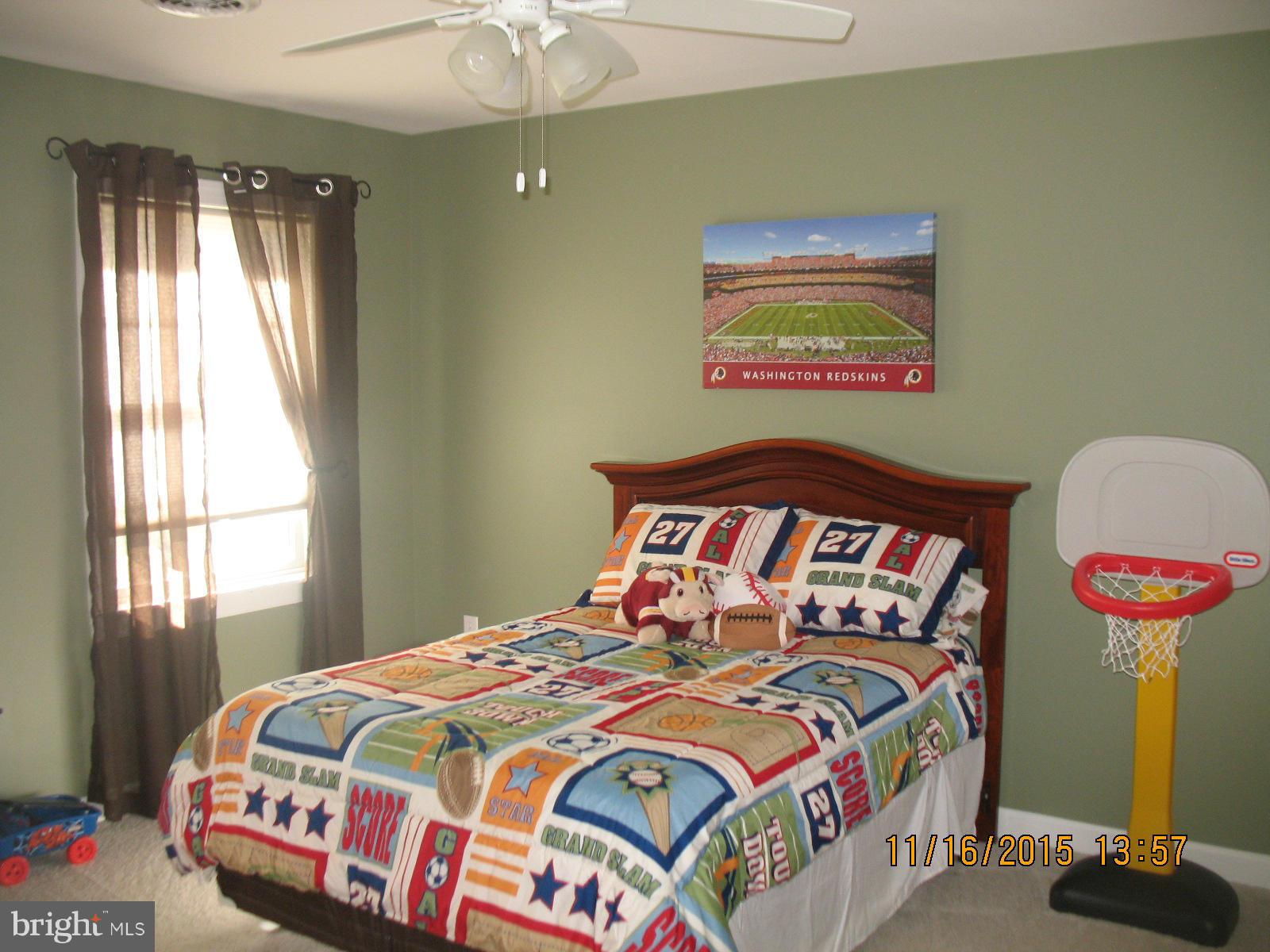 13908 Barnhart Road Clear Spring, MD 21722 - Photo 13 of 16 a bedroom with a bed and a chandelier