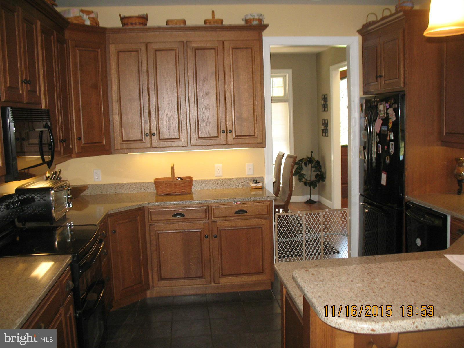 13908 Barnhart Road Clear Spring, MD 21722 - Photo 4 of 16 a kitchen with kitchen island granite countertop a sink stove and cabinets