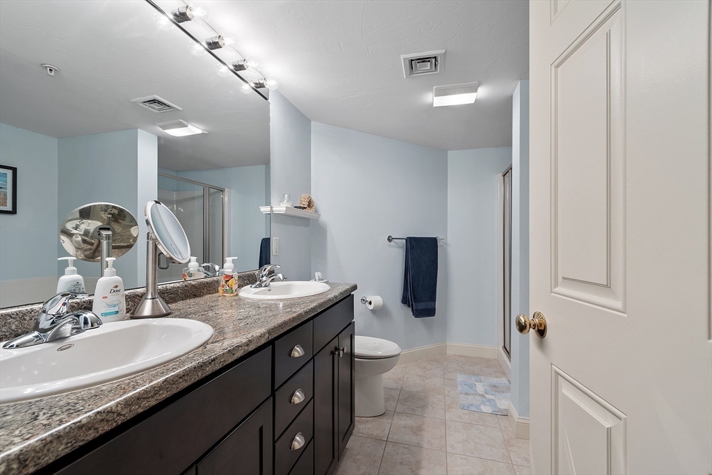4 Sterling Hill Lane, Unit 424 Exeter, NH 03833 - Photo 14 of 24 a bathroom with a sink double vanity granite and shower