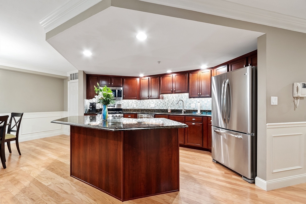 4 Sterling Hill Lane, Unit 424 Exeter, NH 03833 - Photo 5 of 24 a kitchen with stainless steel appliances granite countertop a refrigerator a sink and a stove