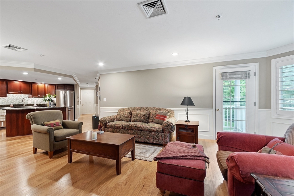 4 Sterling Hill Lane, Unit 424 Exeter, NH 03833 - Photo 8 of 24 a living room with furniture and a large window