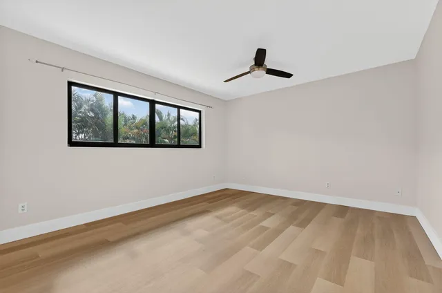 a view of an empty room and wooden floor