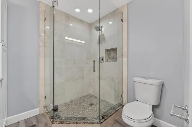 a view of a hallway with wooden floor and entryway