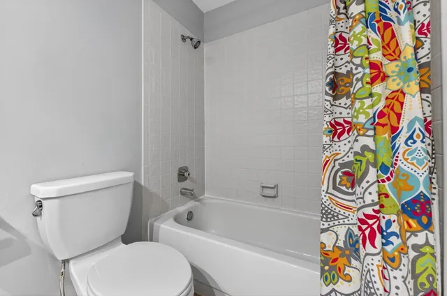 a view of a room with wooden floor and windows