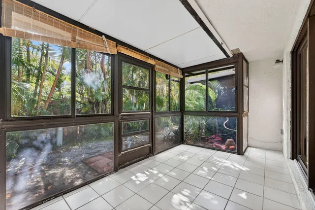 a backyard of a house with plants and outdoor seating