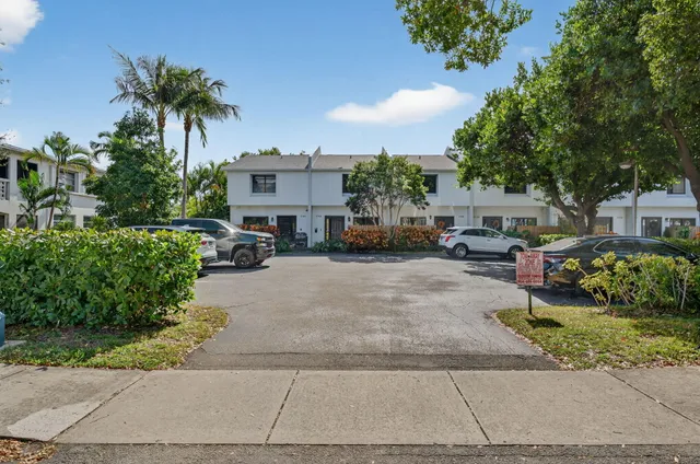an aerial view of a house with a yard and lake view