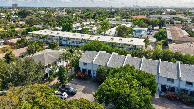 an aerial view of multiple house with a yard