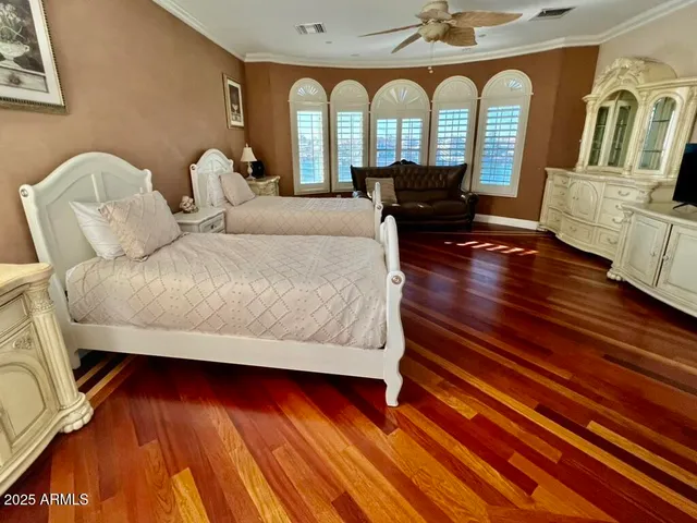 a large bed sitting in a bedroom next to a window