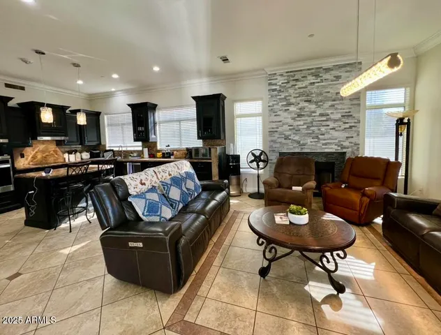 a living room with furniture kitchen view and a fireplace