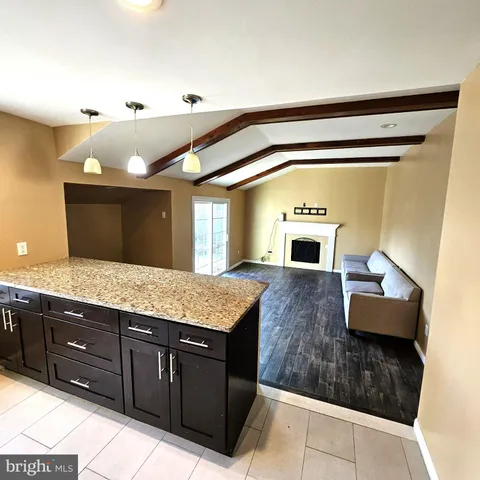 a spacious bathroom with a granite countertop sink and a mirror